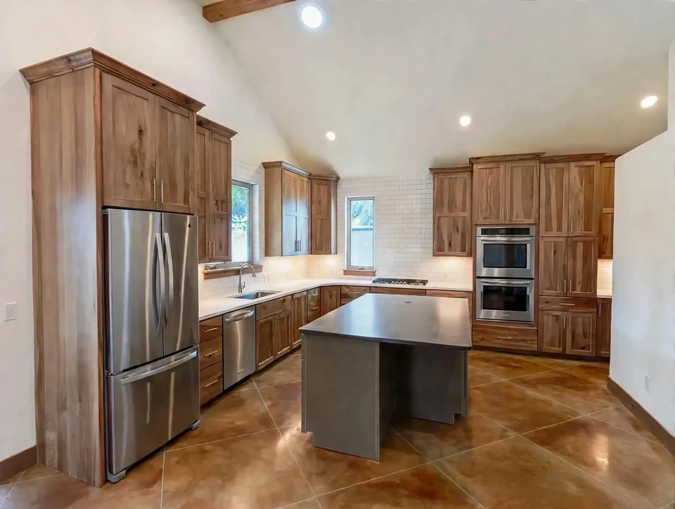 Kitchen with natural wood cabinets, a central island, and recessed ceiling lights.